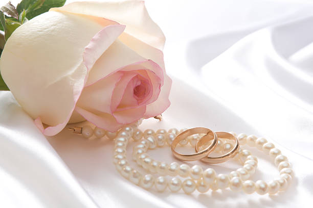 istock Rose, pearls and wedrings over white satin 92183400