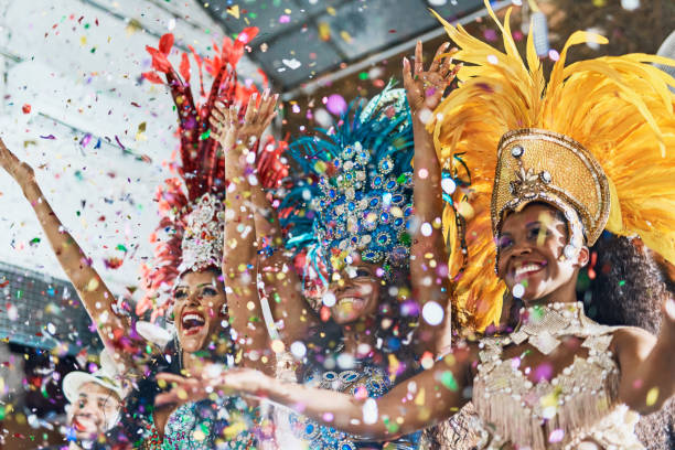 The evening is ours and the music is our friend Cropped shot of beautiful samba dancers performing in a carnival with their band samba dancing stock pictures, royalty-free photos & images