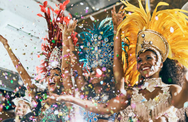 Let's dance all our troubles away Cropped shot of beautiful samba dancers performing in a carnival with their band brazilian culture stock pictures, royalty-free photos & images