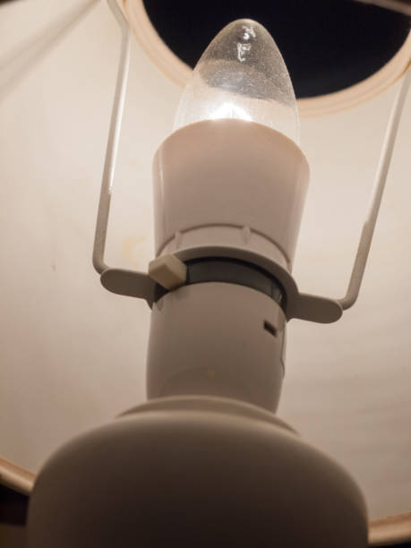 istock close up of lamp bulb in bedside white table lamp 921839392