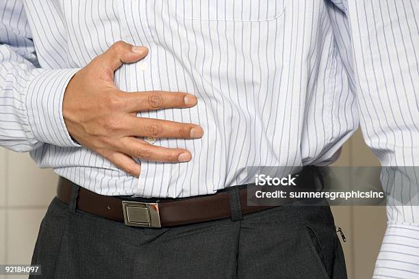 A Man Holding His Hand To His Stomach Stock Photo - Download Image Now - Adult, Adults Only, Color Image