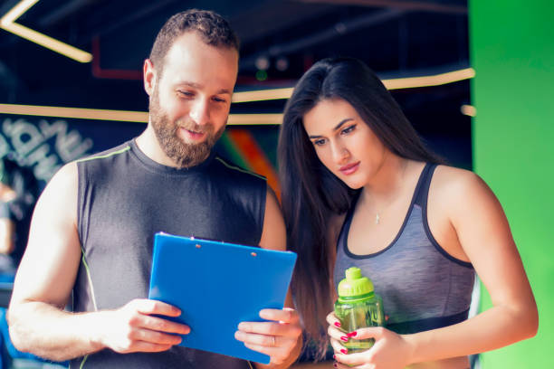 istock Fit woman talking to her trainer 921844348