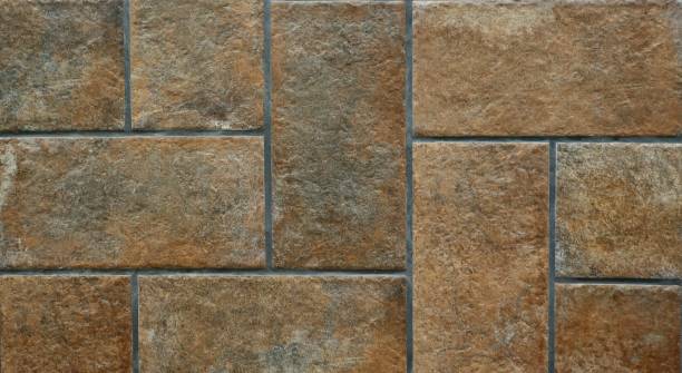 istock Close up of rustic aged floor brown tiles 921844408
