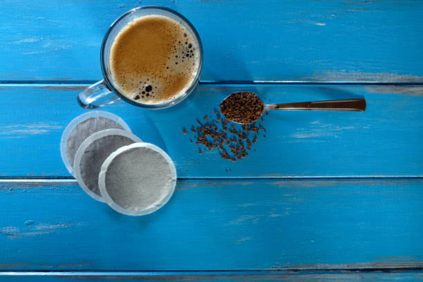 istock Coffee cup with a spoon of instant coffee and coffee pods 921847382