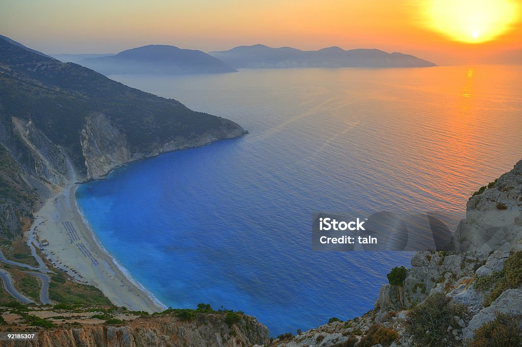 Sunset over Myrtos beach in Polaris, Greece Sunset over the beautiful beach of Myrtos, Kefalonia, Greece Kefalonia Stock Photo