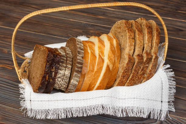 istock Basket with different kind sliced bread on wooden background 921856920