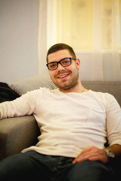istock Young adult handsome man sitting at cafe 921865500