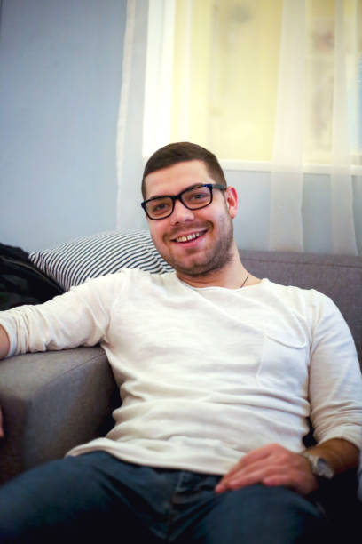istock Young adult handsome man sitting at cafe 921865806