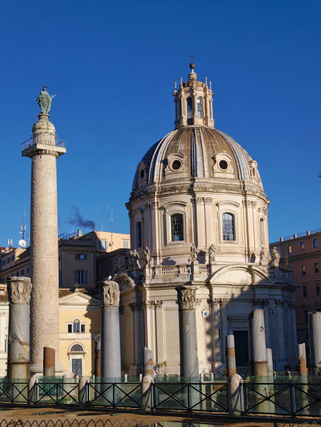istock Trajan's Column and Chiesa SS Nome di Maria Basilica in Rome, Italy 921865896