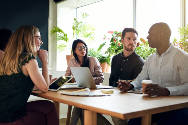istock Diverse business colleagues having a meeting around a boardroom table 921866638