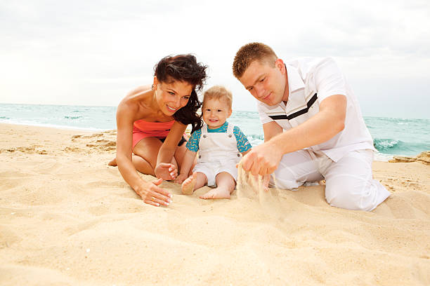 istock Mother, father and baby on beach 92186888