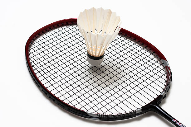 white shuttlecock and badminton racket stock photo