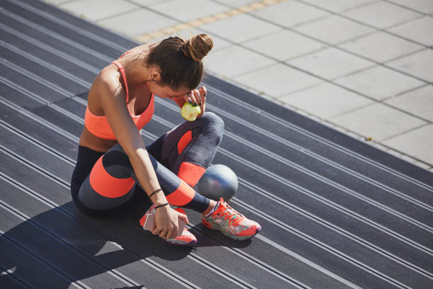 istock Girl sitting on stairs and eating apple. 921870662