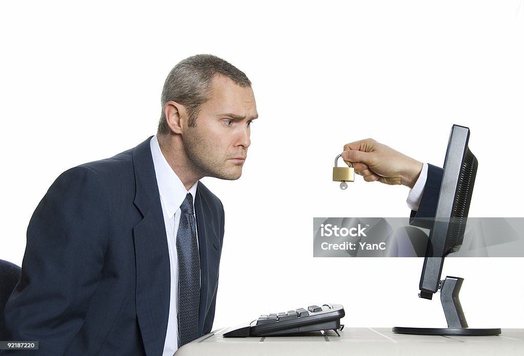 Businessman at computer is alarmed by security features skeptic man in blue suit with internet security Adult Stock Photo