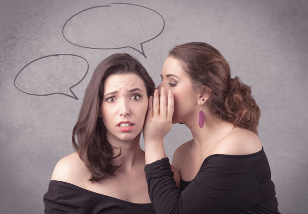 istock girl telling secret things to her girlfriend 921878938