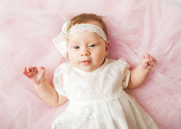 istock baby is lying on the bed in pink dresses 921879424