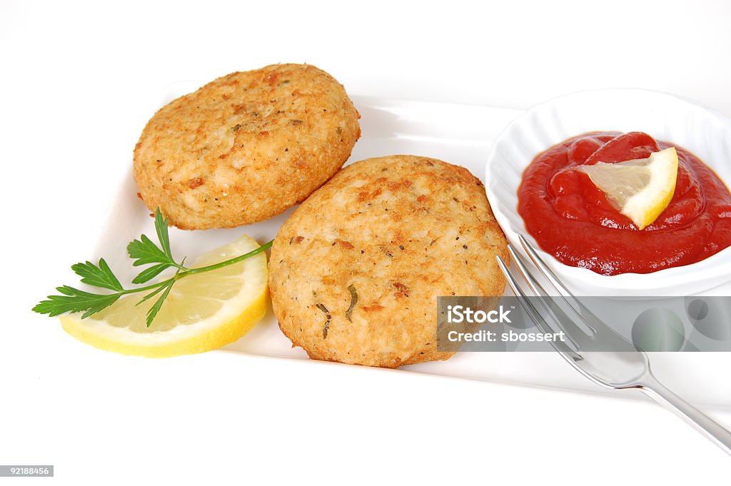 Crab Cakes Crab cake appetizer served with cocktail sauce. Fish Cakes Stock Photo