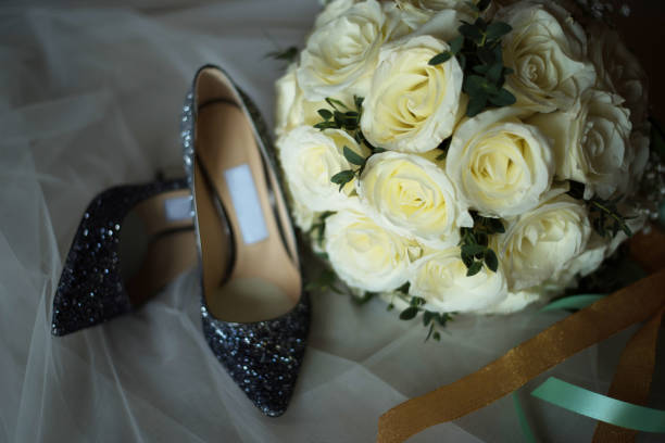 istock Silver lace high heels with white rose bouquet composed with veil 921884666