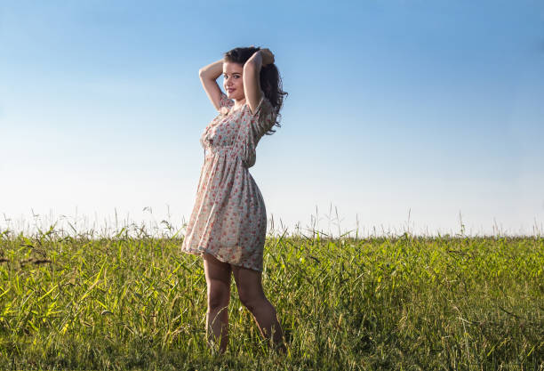 istock Young beautiful woman in the fields 921889246