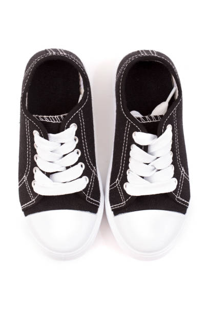 istock Classic Black Shoes Sneakers on a White Background 921889418