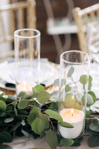 istock Decorated area with white candle and flowers on the table 921889868