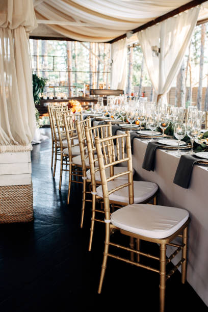 istock Decorated table with gold plates, candles and greens on the white tablecloth 921889954