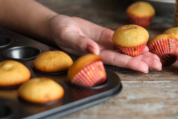 istock small muffins (cupcakes) - fresh pastries on a wooden surface 921890438