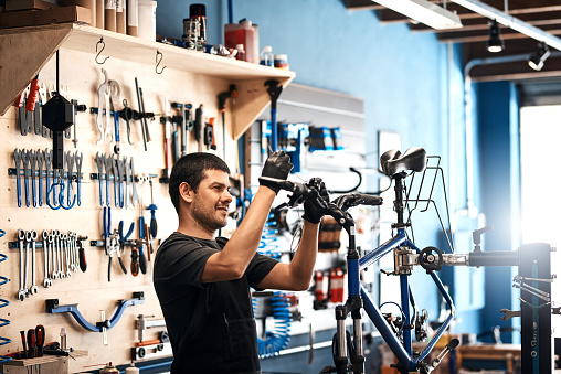 Shot of a man working in a bicycle repair shop