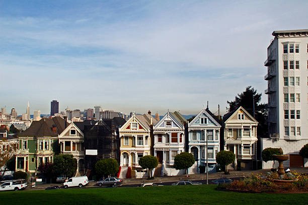 San Francisco residential house architecture with clear blue sky, featuring the upper floors of a row of Victorian houses