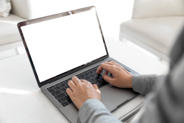 istock Women using laptop with blank screen at table in the office. 921894460