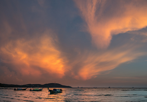 Classic Thailand sunset view with long tail boats, white sand beach, palms, ocean, sun and sky, huge 56MP panorama