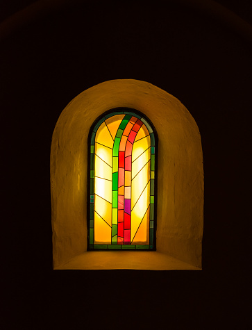 The old and ancient window in dark room .