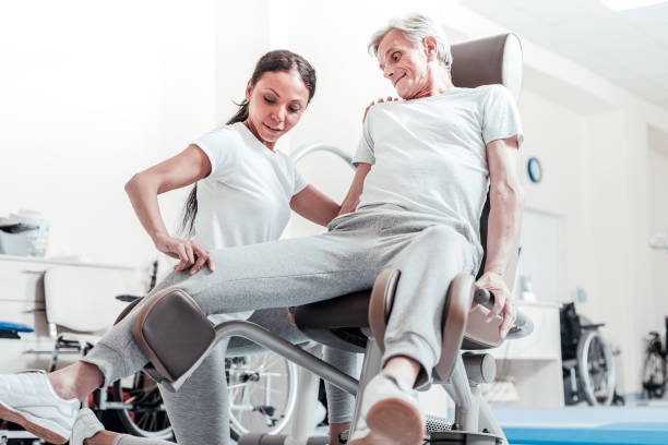 istock Energetic man exercising and a trainer helping him 921897372