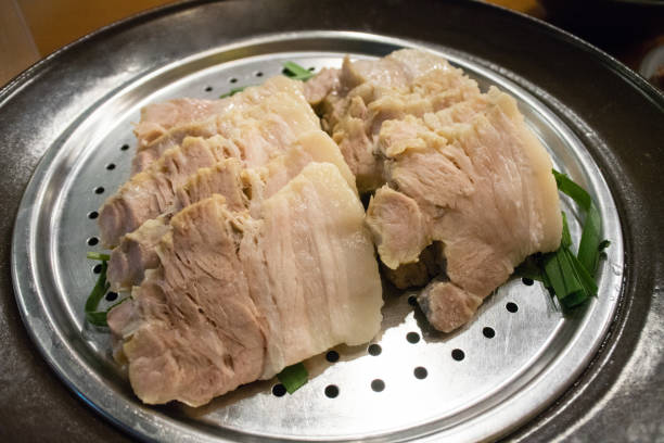 istock stack of slide pork on silver plate in korea restaurant 921897724