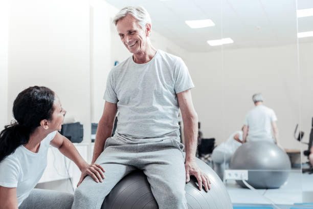 istock Smiling old man and young woman looking at each other 921898244