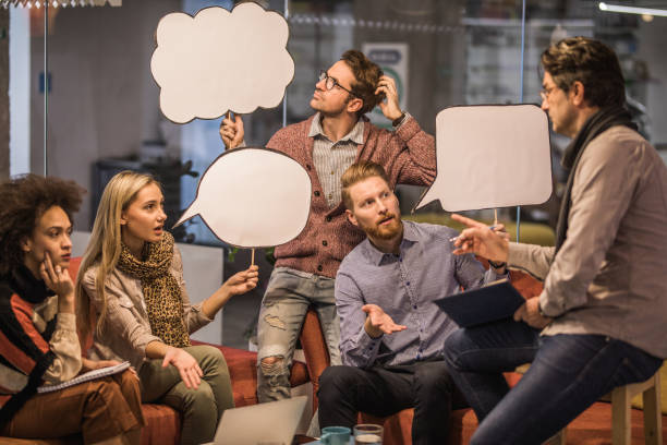 istock Young entrepreneurs with speech bubbles having a meeting with their manager. 921898422