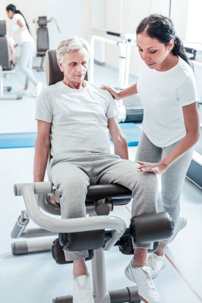 istock Serious old man and his trainer exercising 921902570