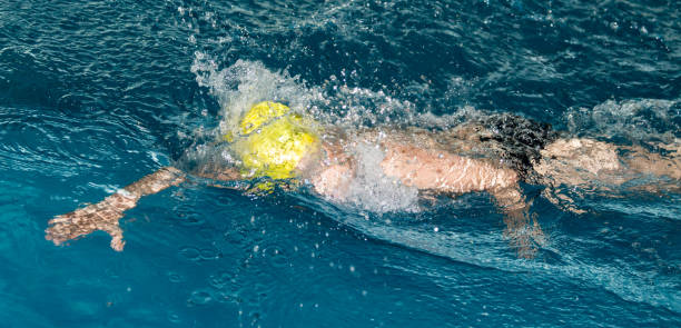 istock boy swimming in the pool 921903702