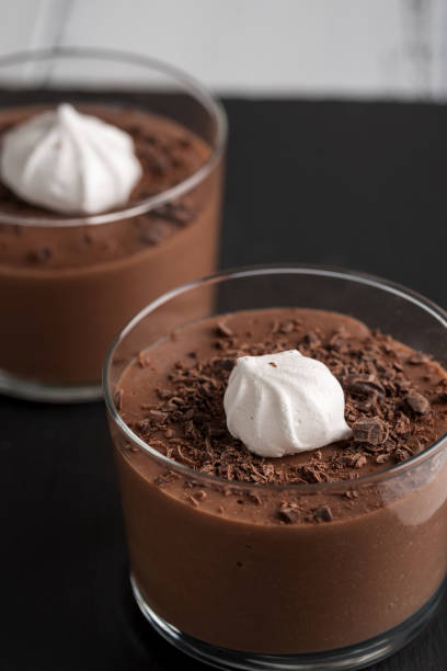 istock Chocolate mousse in a glasses on a black stone background. 921903752