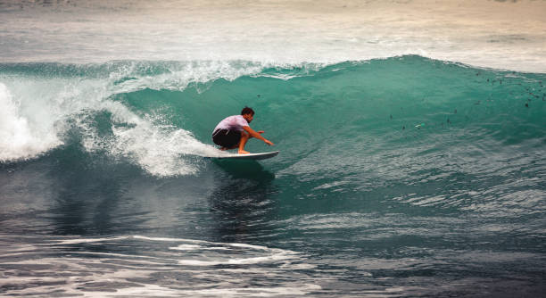 istock Surfer on Blue Ocean Wave, Bali, Indonesia. Riding in tube 921904036