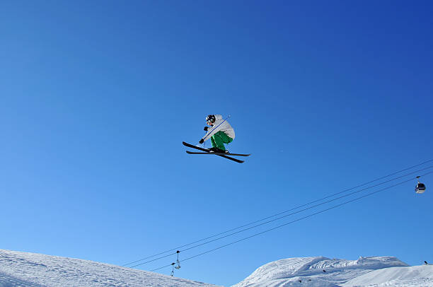 istock skier in green and white on a very high jump 92190716