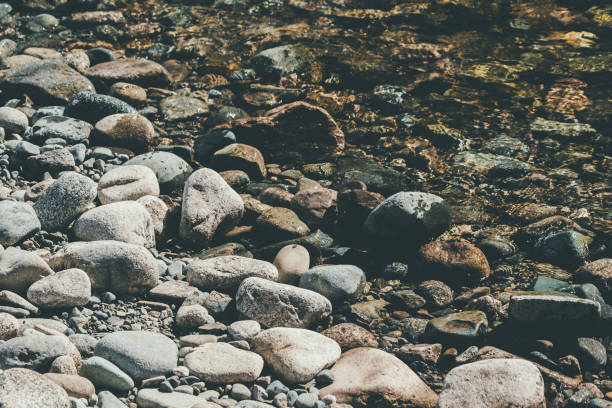 Stones, pebbles and sand on the shore of a mountain river