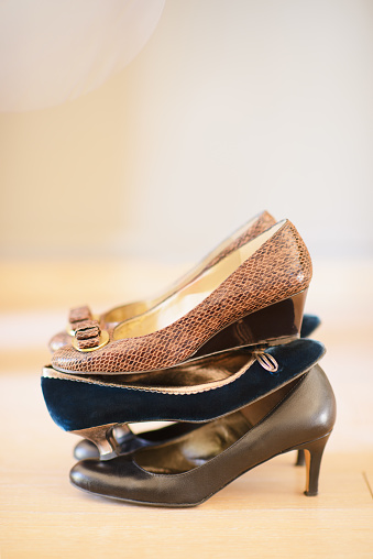 Three pairs of women's high heel shoes in a stack. Representing three people, or decision time.