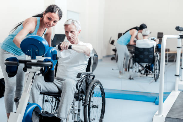istock Serious old man exercising while sitting in a wheelchair 921908950