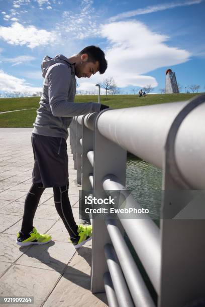 Young Athletic Man Is Preparing Before Running In A City Park In Winter Stock Photo - Download Image Now