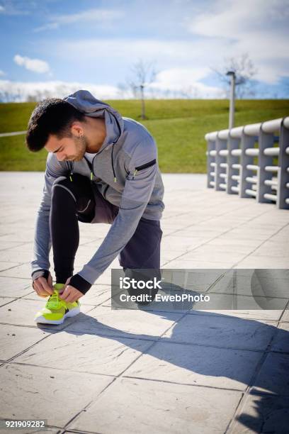Young Athletic Man Is Preparing Before Running In A City Park In Winter Stock Photo - Download Image Now