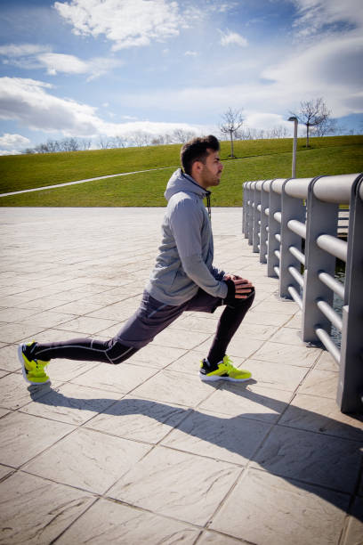 istock Young athletic man is preparing before running in a city park in winter. 921909378