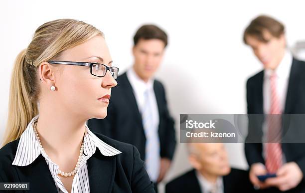 Female Businesswoman Overhears Conversation Of Colleagues Stock Photo - Download Image Now