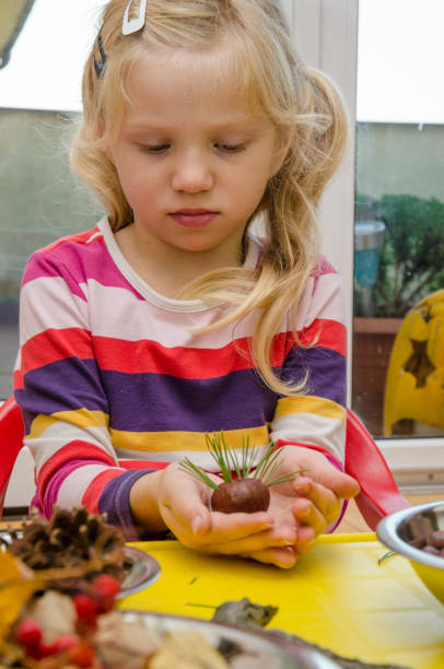 istock child making chestnut figures from autumn chestnuts 921911368