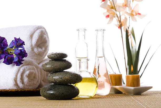 istock Spa products with stones oils candles and rolled towels 92191392